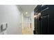 Clean hallway with light grey walls and tile floors leading to an open floor plan at 3702 Palm Desert Ln # 5435, Orlando, FL 32839