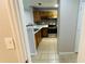 Kitchen view from hallway with stainless appliances and breakfast bar at 3702 Palm Desert Ln # 5435, Orlando, FL 32839