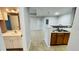 Cozy kitchen with sink, cabinets, and a view of the entryway and bathroom at 3702 Palm Desert Ln # 5435, Orlando, FL 32839