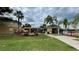 A playground with a red play structure, slide, covered picnic area, and bicycle rack near the community building at 3702 Palm Desert Ln # 5435, Orlando, FL 32839
