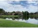 Serene pond view reflecting nearby apartment buildings and lush greenery, enhancing the community's charm at 3702 Palm Desert Ln # 5435, Orlando, FL 32839