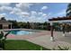 Brick pool perimeter overlooking lake and common grounds with pergola in the background at 3702 Palm Desert Ln # 5435, Orlando, FL 32839