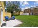 A spacious backyard featuring a patio with seating, a large tree, and ample green space at 3759 Collingwood Ln, Oviedo, FL 32765
