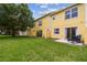 A well-manicured backyard featuring a patio with seating and a lush green lawn at 3759 Collingwood Ln, Oviedo, FL 32765