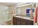 Bathroom featuring double sinks, a full mirror and a glass-enclosed shower at 3759 Collingwood Ln, Oviedo, FL 32765