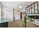 A bright bedroom with a double-door closet and loft bed showcasing wall art and a ceiling fan at 3759 Collingwood Ln, Oviedo, FL 32765