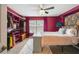 Charming bedroom with a floral headboard, ceiling fan, and organized closet space with bright magenta paint at 3759 Collingwood Ln, Oviedo, FL 32765