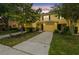 Evening shot of townhouses with a garage and driveway, showcasing the exterior at 3759 Collingwood Ln, Oviedo, FL 32765