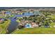 Breathtaking aerial view of a lakefront community showcasing homes, lush greenery, amenities, and a sparkling lake at 3824 Gulf Shore Cir, Kissimmee, FL 34746