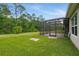 The backyard features a screened patio and a beautiful lawn at 3824 Gulf Shore Cir, Kissimmee, FL 34746
