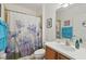 This bathroom includes a shower-tub combination with a blue floral shower curtain at 3824 Gulf Shore Cir, Kissimmee, FL 34746