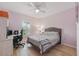 Bedroom featuring purple walls, a ceiling fan, and a window with plantation shutters at 3824 Gulf Shore Cir, Kissimmee, FL 34746