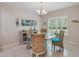 Inviting breakfast nook features a round table, wicker chairs, and bright natural light from large windows at 3824 Gulf Shore Cir, Kissimmee, FL 34746