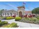 Inviting community clubhouse featuring well-maintained landscaping, a walkway, and beautiful architectural details at 3824 Gulf Shore Cir, Kissimmee, FL 34746