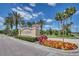 Beautiful community entrance sign surrounded by lush landscaping and vibrant flowers, welcoming residents and visitors alike at 3824 Gulf Shore Cir, Kissimmee, FL 34746