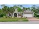 Charming single-Gathering home boasting a well-kept lawn, decorative shutters, and a convenient two-car garage at 3824 Gulf Shore Cir, Kissimmee, FL 34746