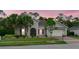 Inviting single-Gathering home featuring lush landscaping, red shutters, and a convenient two-car garage at 3824 Gulf Shore Cir, Kissimmee, FL 34746