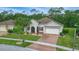 Lovely home with lush greenery, a brick-paved driveway, a two car garage and a well-maintained lawn at 3824 Gulf Shore Cir, Kissimmee, FL 34746