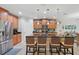 Spacious kitchen featuring a large island with bar stools and modern lighting fixtures at 3824 Gulf Shore Cir, Kissimmee, FL 34746