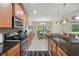 Bright kitchen boasts stainless appliances, granite countertops, and seamless flow to breakfast nook at 3824 Gulf Shore Cir, Kissimmee, FL 34746