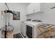 Laundry room featuring white cabinets, a utility sink, washer, and dryer at 3824 Gulf Shore Cir, Kissimmee, FL 34746