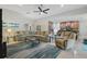 Spacious living room boasts an open concept to the kitchen, neutral tones, and a ceiling fan at 3824 Gulf Shore Cir, Kissimmee, FL 34746