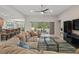 Open-concept living room with sliding glass doors, ceiling fan, and seamless flow to kitchen/breakfast area at 3824 Gulf Shore Cir, Kissimmee, FL 34746