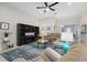 Open-concept living room featuring a large entertainment center and comfortable seating arrangement at 3824 Gulf Shore Cir, Kissimmee, FL 34746