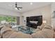 Bright living room with open floor plan, sliding glass doors and an entertainment center at 3824 Gulf Shore Cir, Kissimmee, FL 34746