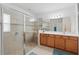 The bright, tiled main bathroom features a glass enclosed shower and dual sink vanity at 3824 Gulf Shore Cir, Kissimmee, FL 34746