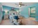 Bright main bedroom showcases a chair, nightstands, updated furniture, and adjoins sitting area at 3824 Gulf Shore Cir, Kissimmee, FL 34746