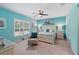Bright main bedroom features blue accent wall, ceiling fan, plantation shutters, and updated furniture at 3824 Gulf Shore Cir, Kissimmee, FL 34746