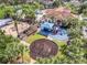 Aerial view of a well-equipped playground with swings, slides, and play structures surrounded by lush landscaping at 3824 Gulf Shore Cir, Kissimmee, FL 34746