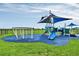 Modern playground featuring fun slides and interactive play structures, set against a backdrop of lush greenery at 3824 Gulf Shore Cir, Kissimmee, FL 34746