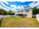 Spacious backyard featuring a covered patio and white vinyl fence, great for entertaining at 4113 Stonefield Dr, Orlando, FL 32826