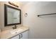 Clean bathroom with a white vanity and a framed mirror at 4113 Stonefield Dr, Orlando, FL 32826