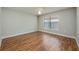 This is a bedroom with hardwood floors, ceiling fan, and a large window offering plenty of natural light at 4113 Stonefield Dr, Orlando, FL 32826