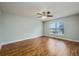 This is a bedroom with hardwood floors, ceiling fan, and a large window offering plenty of natural light at 4113 Stonefield Dr, Orlando, FL 32826