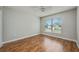 Well-lit bedroom with wood-look flooring, a ceiling fan and a window for a bright and airy living space at 4113 Stonefield Dr, Orlando, FL 32826