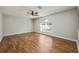 This is a bedroom with hardwood floors, ceiling fan, and a large window offering plenty of natural light at 4113 Stonefield Dr, Orlando, FL 32826