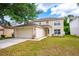 Beautiful two-story home featuring an attached two-car garage and well-maintained landscaping at 4113 Stonefield Dr, Orlando, FL 32826
