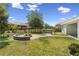 Fenced backyard includes a brick fire pit, landscaped walkways, and hot tub at 4153 Cortland Dr, Davenport, FL 33837