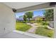 Covered patio view of backyard with fire pit and meticulous landscaping at 4153 Cortland Dr, Davenport, FL 33837