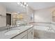 Spacious bathroom with double sinks, large mirror and separate tub and glass shower with tan tiling at 4153 Cortland Dr, Davenport, FL 33837