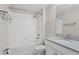 This bathroom features a shower and tub combination with a white tile surround and stone countertop at 4153 Cortland Dr, Davenport, FL 33837