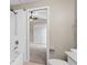 This bathroom features a bathtub with shower head, toilet, and an open door into a bedroom with double closet at 4153 Cortland Dr, Davenport, FL 33837