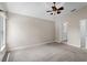 Spacious bedroom with carpet, neutral wall paint, ceiling fan, and bathroom accessible from bedroom at 4153 Cortland Dr, Davenport, FL 33837