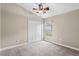 Neutral bedroom features a ceiling fan, closet and a window with natural light and beige carpet at 4153 Cortland Dr, Davenport, FL 33837