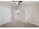 Neutral carpeted bedroom features a closet, ceiling fan and opens to a bathroom and other rooms at 4153 Cortland Dr, Davenport, FL 33837