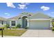 Lovely single-story home with an attached two-car garage, mature landscaping, and a well-kept lawn at 4153 Cortland Dr, Davenport, FL 33837